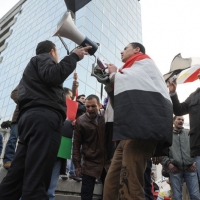 Foto Nicoloro G. 04/03/2011 Milano Manifestazione in piazza Loreto con corteo di un centinaio di immigrati libici contro il regime di Gheddafi a cui hanno partecipato anche immigrati tunisini ed egiziani. nella foto Manifestanti con altoparlante, bandiere e cartelli