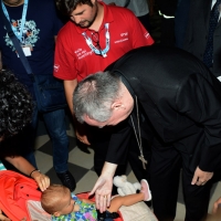 Foto Nicoloro G. 26/08/2017 Rimini Settima ed ultima giornata della 38° edizione del Meeting di Rimini che quest' anno ha come tema ' Quello che tu erediti dai tuoi padri, riguadagnatelo, per possederlo”. nella foto il cardinale Pietro Parolin, Segretario di Stato di Sua Santita', si ferma a salutare un bimbo.