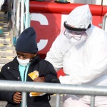 Foto Nicoloro G.   31/12/2022   Porto Corsini ( Ravenna )   La nave Ocean Viking con 113 migranti a bordo ha attraccato alla banchina del Terminal Crociere di Porto Corsini. nella foto lo sbarco di un bambino non accompagnato.