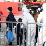 Foto Nicoloro G.   31/12/2022   Porto Corsini ( Ravenna )   La nave Ocean Viking con 113 migranti a bordo ha attraccato alla banchina del Terminal Crociere di Porto Corsini. nella foto donne con figli si portano alla prima accoglienza.