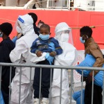 Foto Nicoloro G.   31/12/2022   Porto Corsini ( Ravenna )   La nave Ocean Viking con 113 migranti a bordo ha attraccato alla banchina del Terminal Crociere di Porto Corsini. nella foto donne con figli si portano alla prima accoglienza.