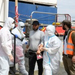 Foto Nicoloro G.   25/05/2024   Ravenna   E\' approdata nel porto di Ravenna la nave ong Sea Eye con a bordo 52 migranti di cui 6 minori. nella foto il primo migrante che sbarca viene accompagnato all\' autoambulanza che lo portera\' in ospedale perche\' bisognoso di cure immediate.