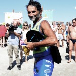 Foto Nicoloro G.   15/08/2022   Cervia (RA)   30° edizione di \' Cervia, la spiaggia ama il libro \' con il tradizionale arrivo degli scrittori dal mare su storiche imbarcazioni e sbarco sulla spiaggia di Cervia. nella foto l\' ironman Andrea Pelo di Giorgio che e\' arrivato a nuoto.