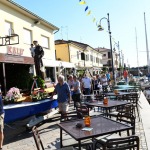 Foto Nicoloro G.   Cervia (RA)   13/06/2022   Festeggiamenti in onore di Sant\' Antonio, protettore dei marinai e dei salinari, con corteo che raggiungera\' il porto da dove la statua del Santo verra\' imbarcata e portata in mare aperto per la tradizionale benedizione e lancio in mare di una corona . nella foto durante la processione con i pescatori che spingono la statua di Sant\' Antonio verso il porto per l\' imbarco.