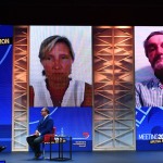 Foto Nicoloro G.   21/08/2020   Rimini    Quarta giornata del Meeting di CL 2020, che in questa edizione ha per titolo ' Privi di meraviglia, restiamo sordi al sublime '. nella foto a sinistra il governatore della Sicilia Nello Musumeci e Gianluca Comin, presidente della Comin & Partners mentre seguono la diretta video di Sabina Nuti, rettrice della Scuola Superiore Sant' Anna di Pisa e di Attilio Fontana, governatore della Lombardia.