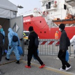 Foto Nicoloro G.   18/02/2023   Porto Corsini ( Ravenna )   La nave Ocean Viking dell' Ong Sos Mediterranee e' sbarcata con a bordo 84 naufraghi di cui 58 minori non accompagnati e 26 uomini adulti. nella foto alcuni migranti appena sbarcati vengono introdotti nel capannone di prima accoglienza.